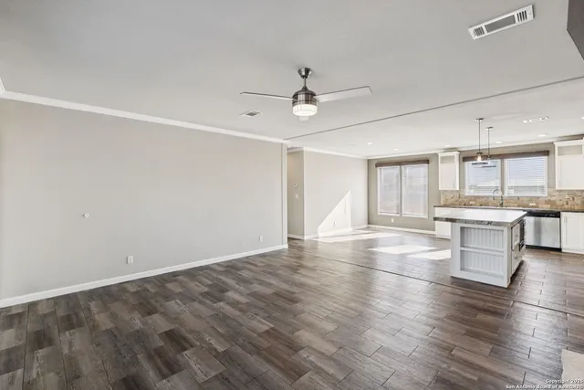 a view of kitchen and hall with wooden floor
