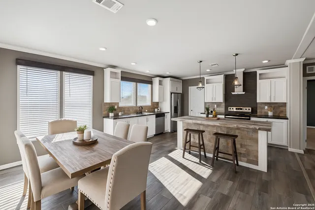 a kitchen with a table chairs stove and kitchen island