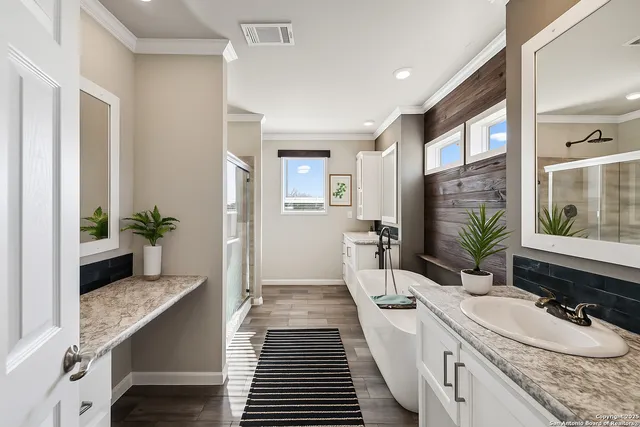 a bathroom with a granite countertop sink a mirror and a shower