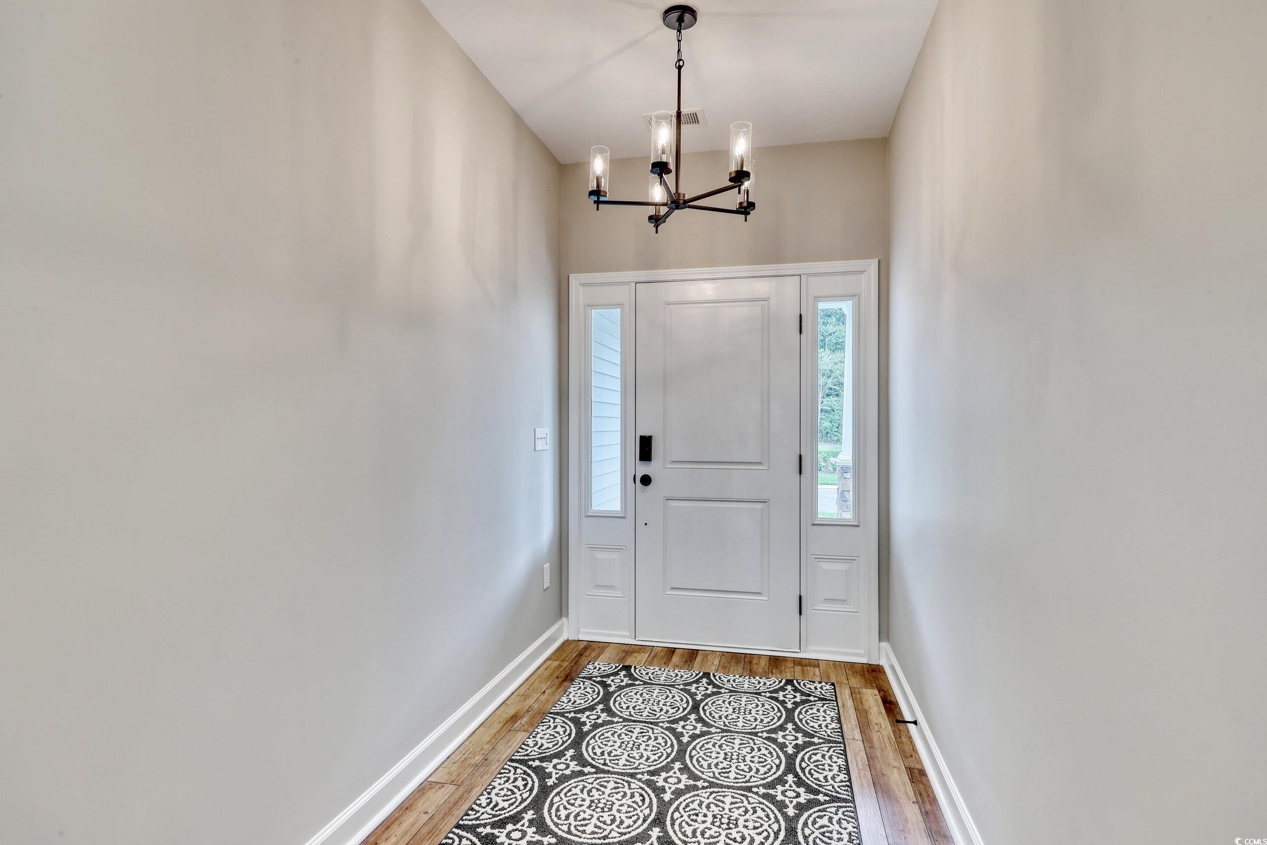 Entrance foyer with hardwood / wood-style flooring