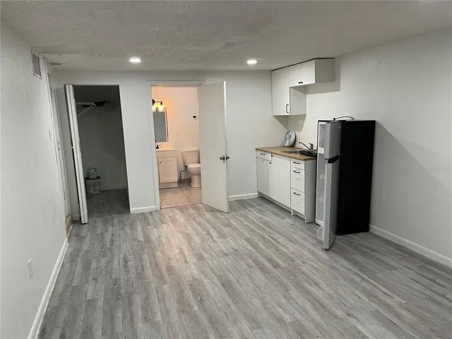a kitchen with granite countertop wooden cabinets and a stainless steel appliances