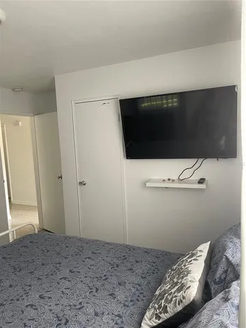 a bedroom with bed and a window