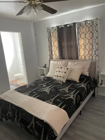 a bedroom with a bed and a flat tv screen