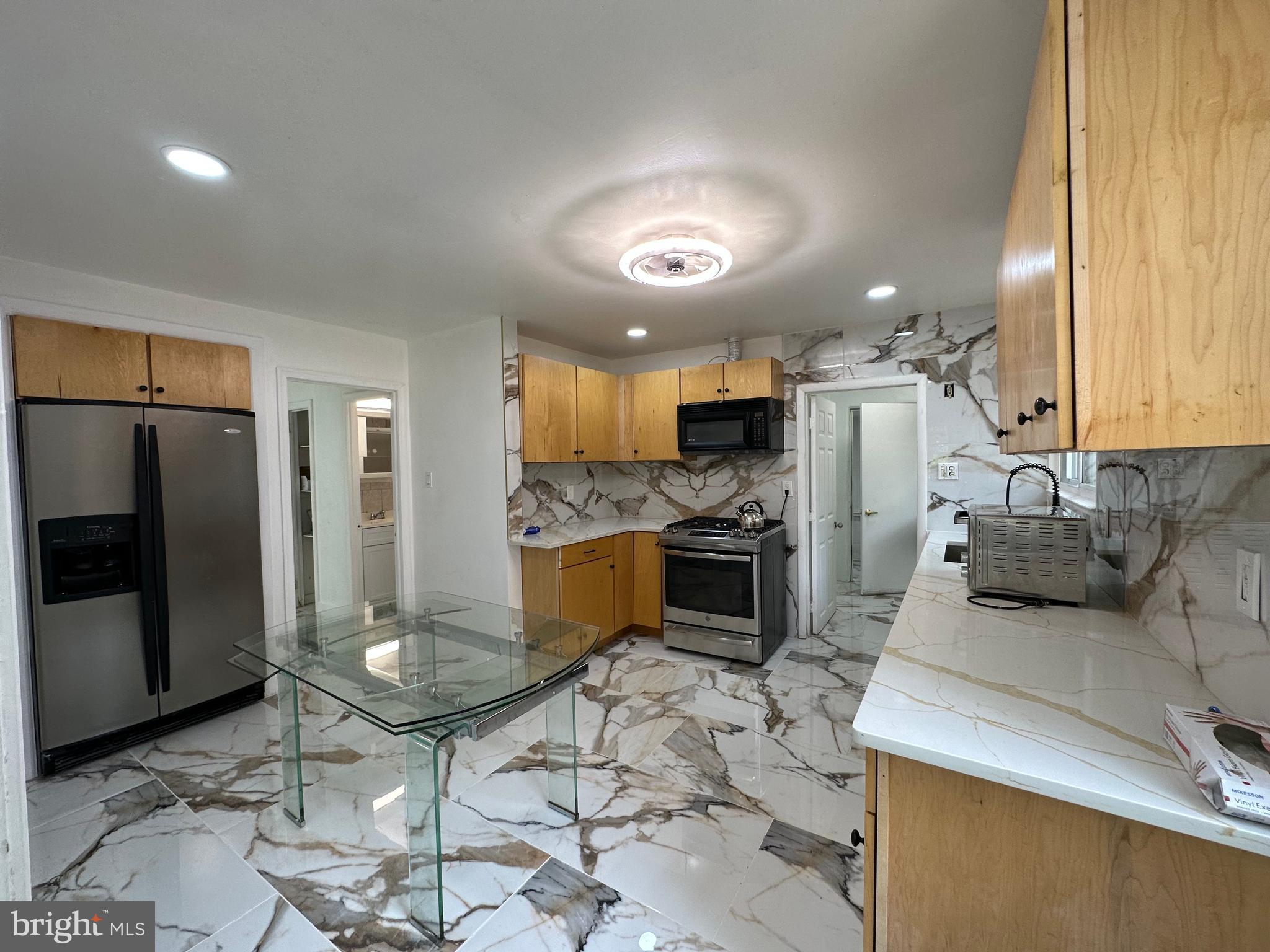 682 Rennard Street Philadelphia, PA 19116 - Photo 19 of 24 a kitchen with refrigerator and cabinets