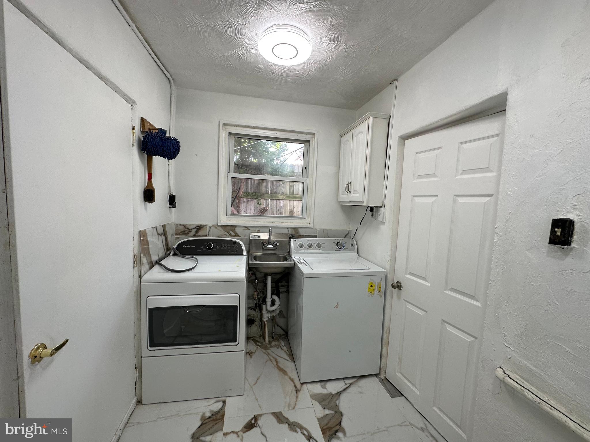 682 Rennard Street Philadelphia, PA 19116 - Photo 21 of 24 a utility room with dryer and washer
