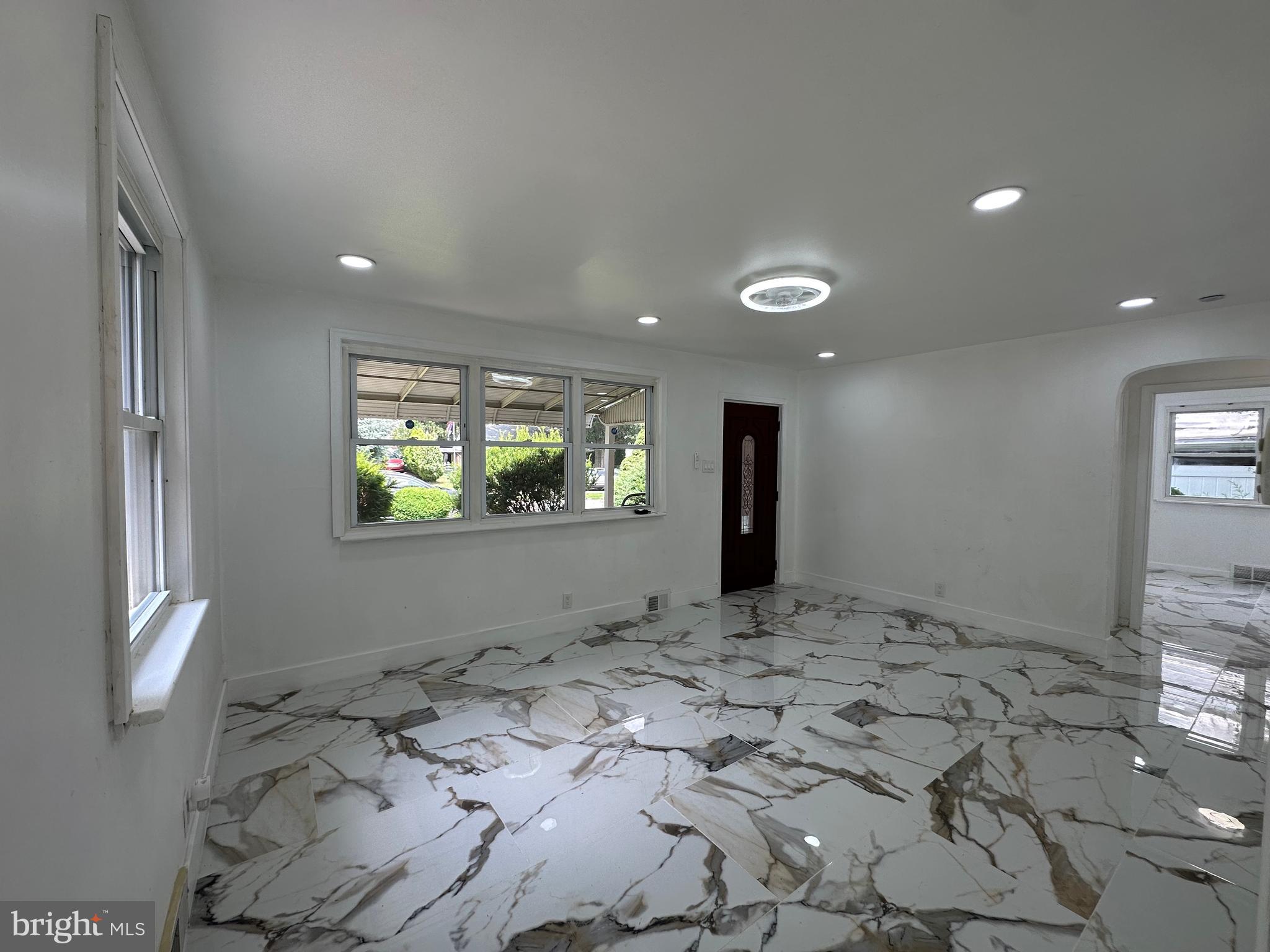 682 Rennard Street Philadelphia, PA 19116 - Photo 4 of 24 a view of a hallway to a bedroom with window