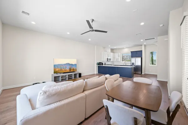 a living room with furniture and kitchen view
