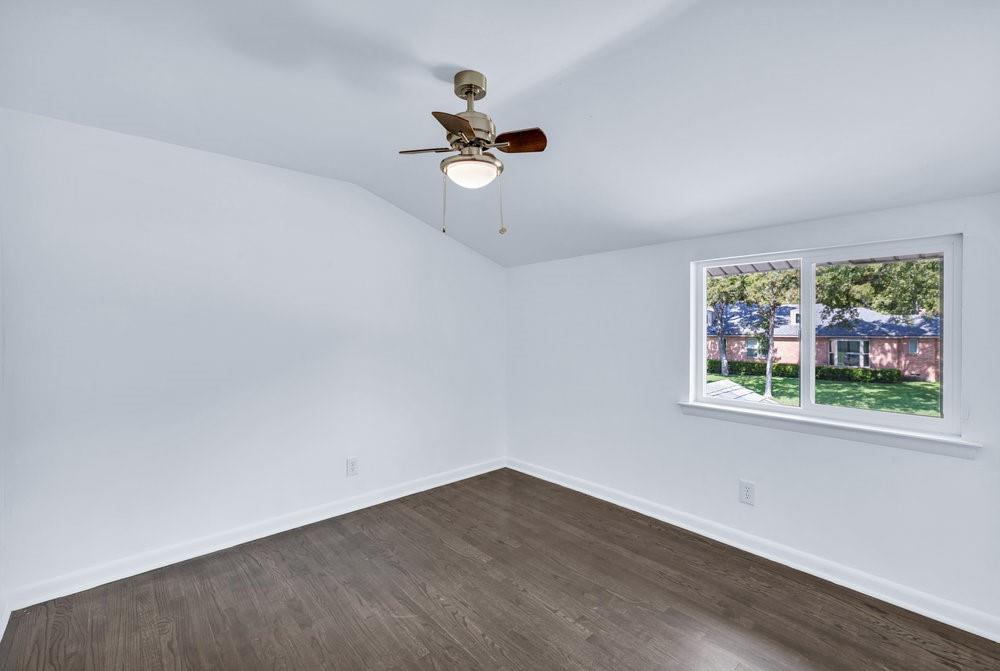 312 West Rio Grande Street Garland, TX 75041 - Photo 14 of 35 an empty room with wooden floor fan and windows