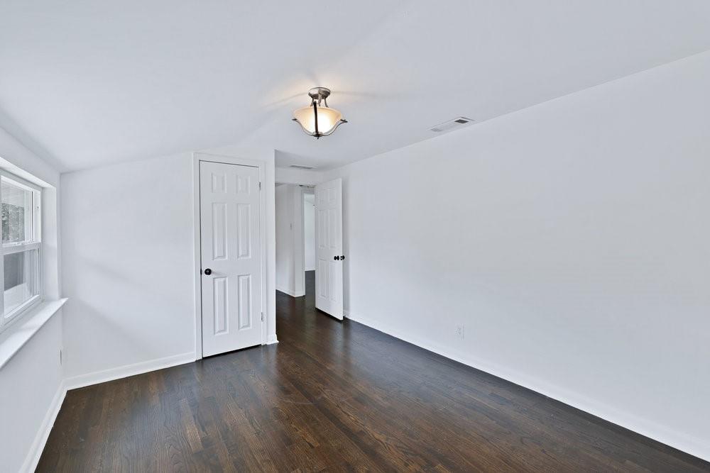 312 West Rio Grande Street Garland, TX 75041 - Photo 15 of 35 a view of a room with wooden floor and window