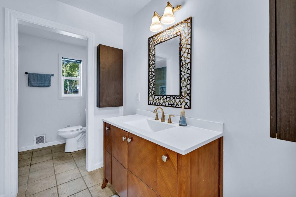 312 West Rio Grande Street Garland, TX 75041 - Photo 16 of 35 a bathroom with a toilet sink and mirror