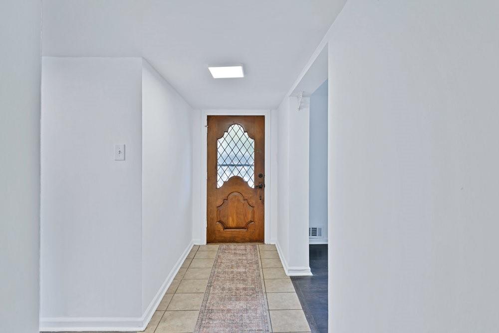 312 West Rio Grande Street Garland, TX 75041 - Photo 2 of 35 a hallway with white doors wooden floor and glass door