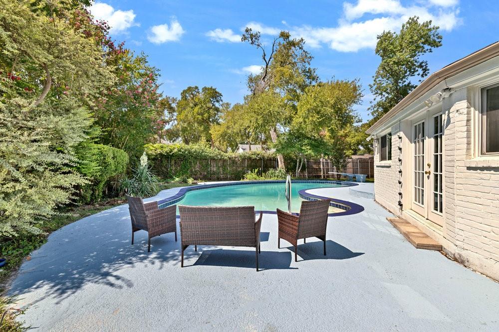 312 West Rio Grande Street Garland, TX 75041 - Photo 30 of 35 a swimming pool with outdoor seating and trees