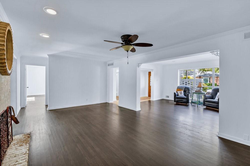 312 West Rio Grande Street Garland, TX 75041 - Photo 8 of 35 a view of a livingroom with hardwood floor and a ceiling fan