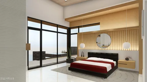 a bedroom with a bed and a large window