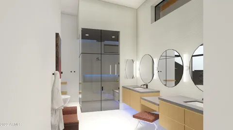 a bathroom with a double vanity sink a toilet and shower