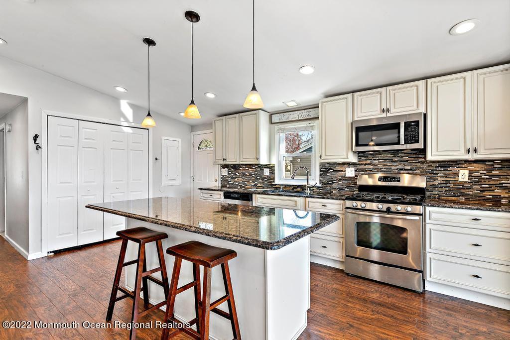 36 Cabana Drive Brick, NJ 08723 - Photo 20 of 42 a kitchen with stainless steel appliances granite countertop a stove a sink and a microwave