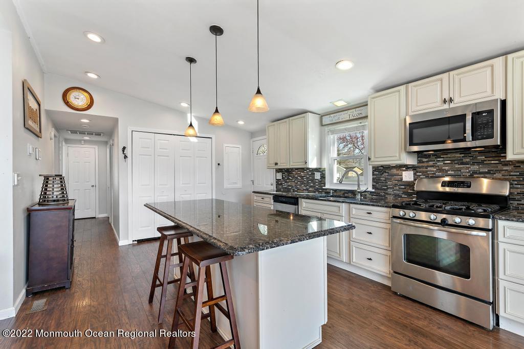 36 Cabana Drive Brick, NJ 08723 - Photo 24 of 42 a kitchen with stainless steel appliances granite countertop a stove a sink and a microwave