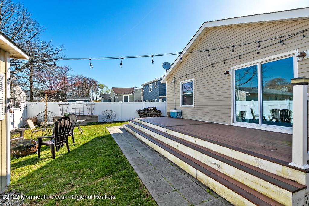 36 Cabana Drive Brick, NJ 08723 - Photo 35 of 42 a view of a patio with chairs and floor to ceiling window next to a yard