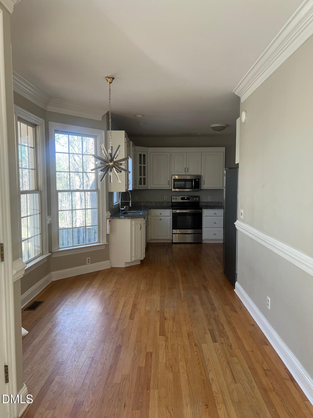 402 Cricket Hearth Road Sanford, NC 27330 - Photo 14 of 67 a kitchen with stainless steel appliances granite countertop a stove and a wooden floors