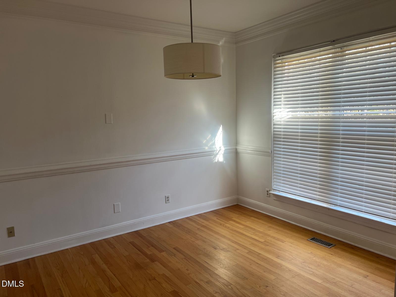 402 Cricket Hearth Road Sanford, NC 27330 - Photo 8 of 67 a view of a room with wooden floor and white walls