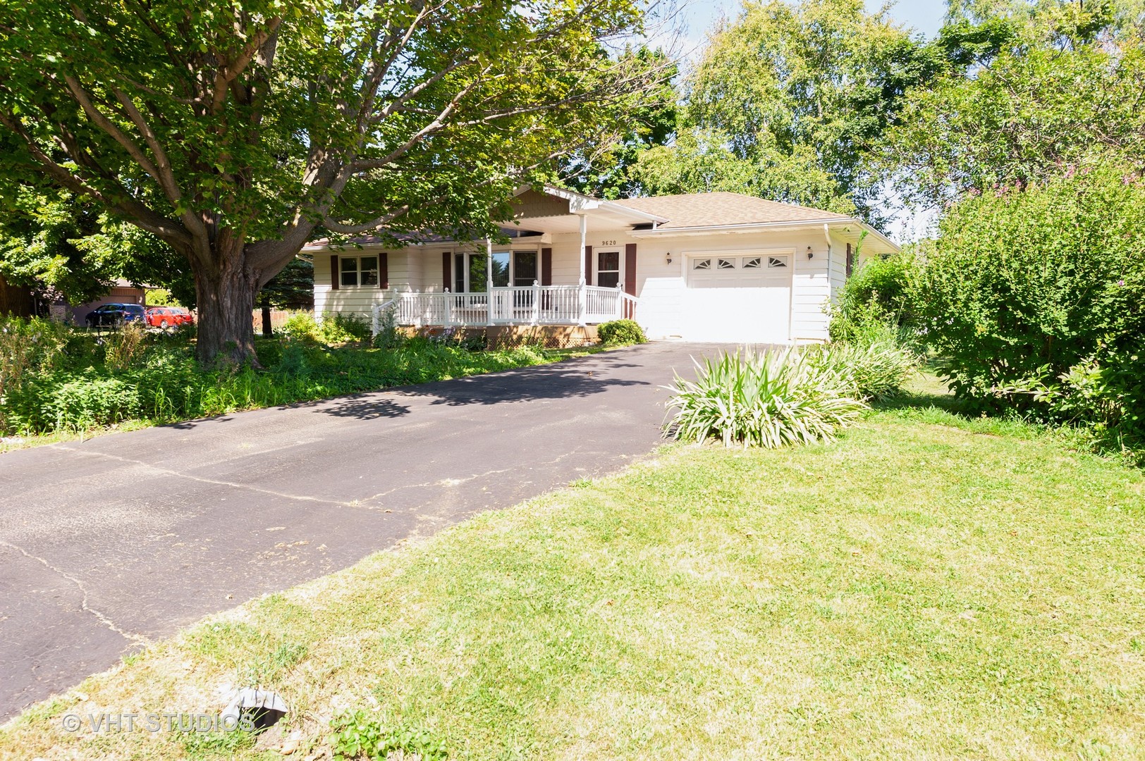 9620 Jean Drive Hebron, IL 60034 - Photo 2 of 11 a front view of a house with a yard and a garage
