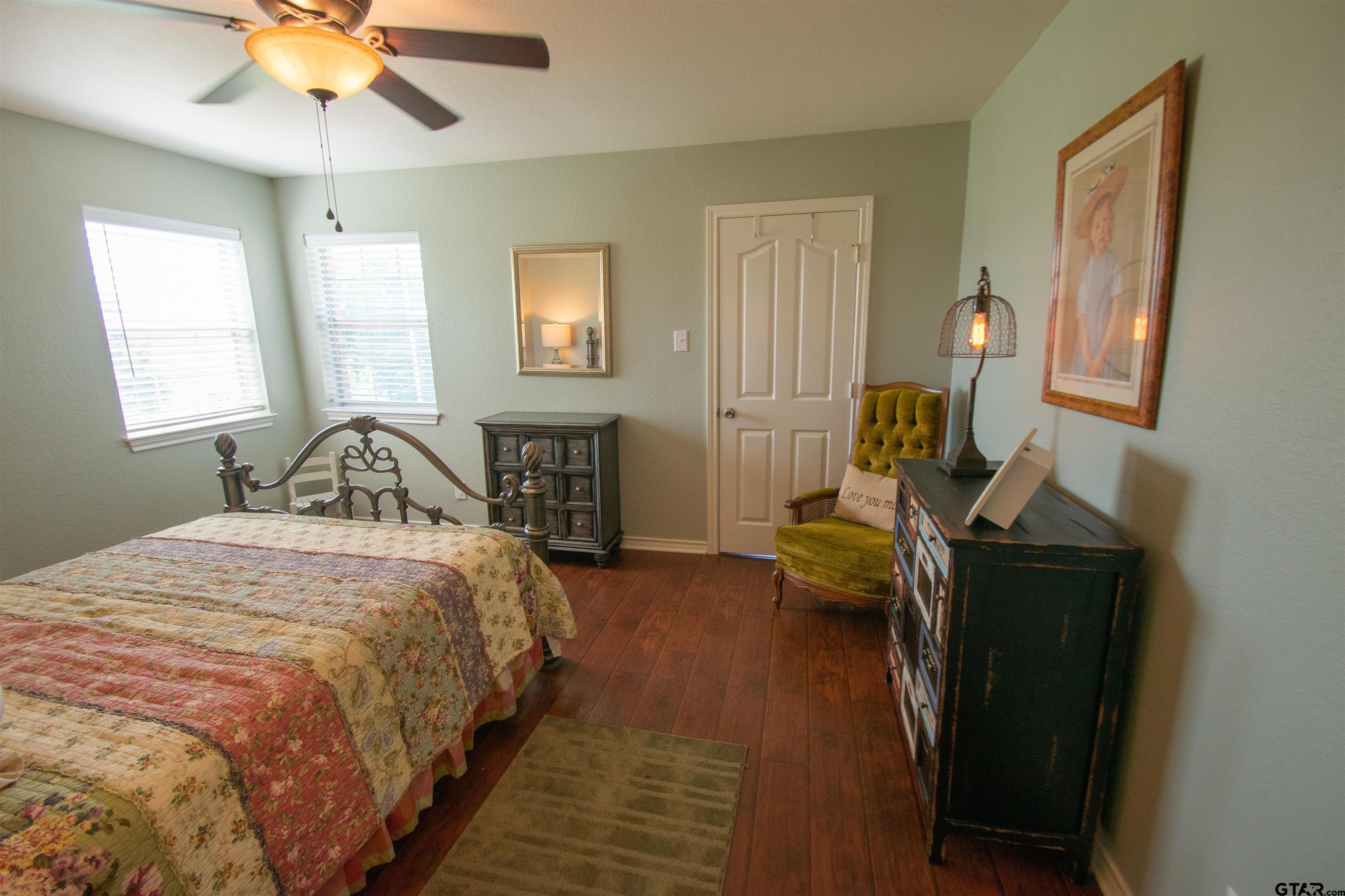 23120 Saddle Ridge Court Lindale, TX 75771 - Photo 24 of 37 a bedroom with a bed and a chandelier