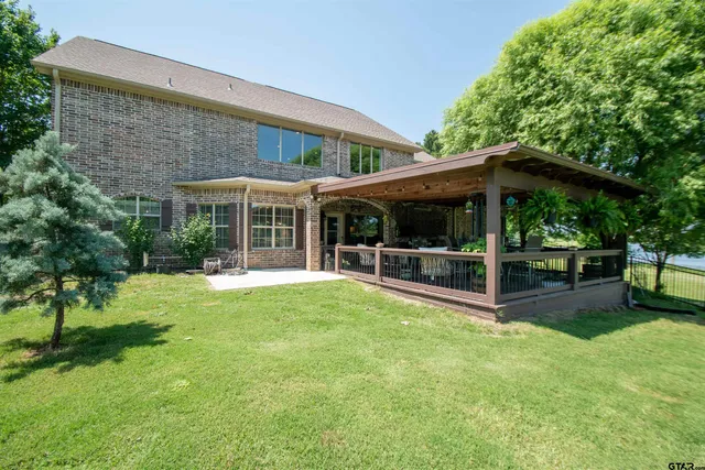 a view of a house with a yard patio and a garden