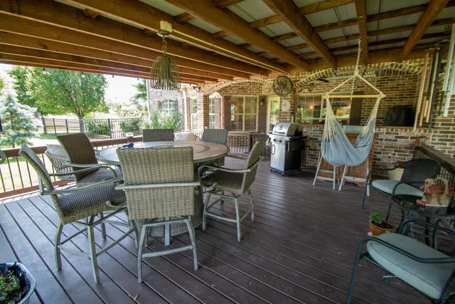 a view of a patio with table and chairs and wooden floor