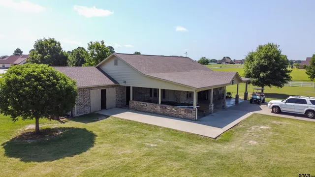 a view of a house with swimming pool and sitting area
