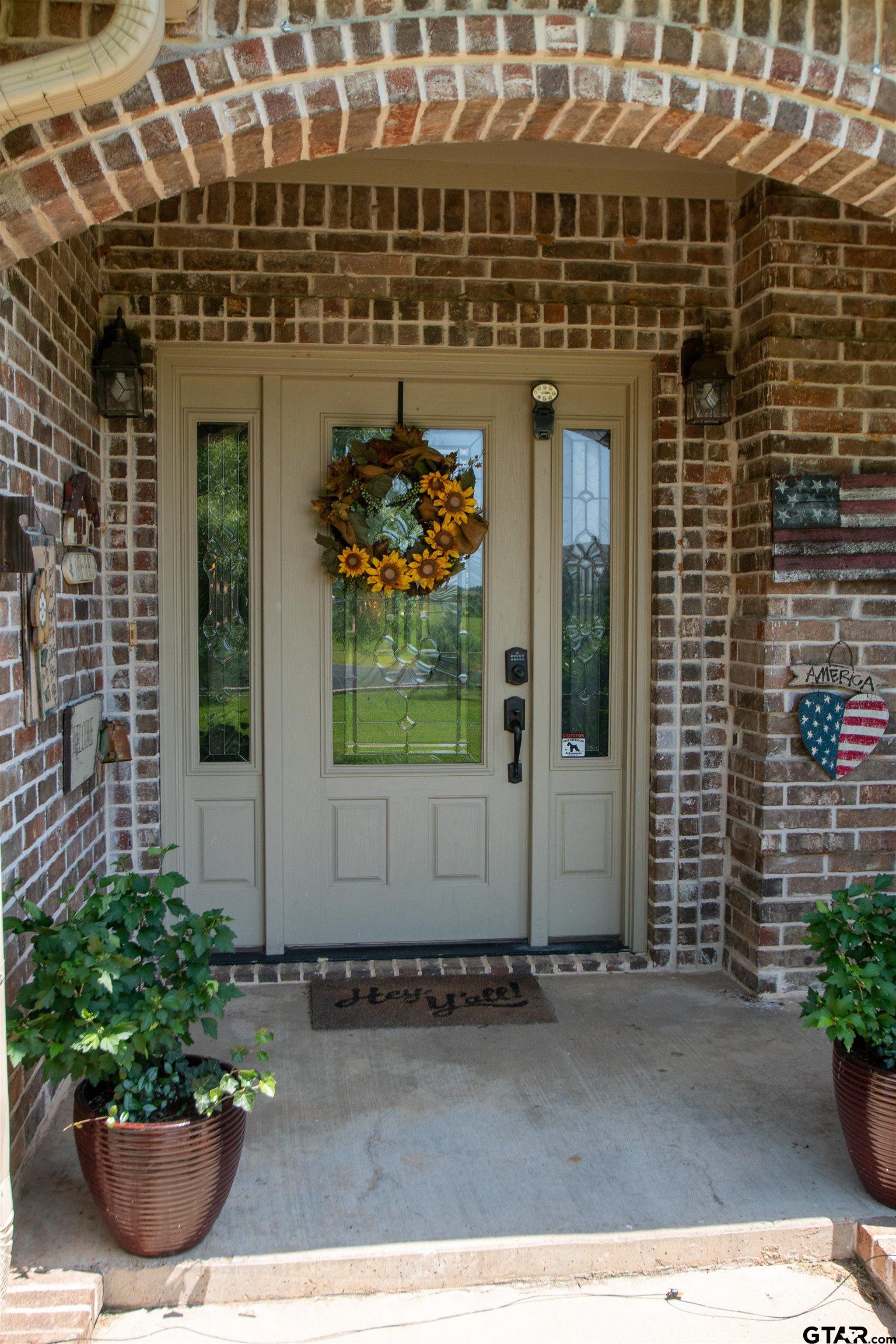 23120 Saddle Ridge Court Lindale, TX 75771 - Photo 4 of 37 a front view of a building with a garden