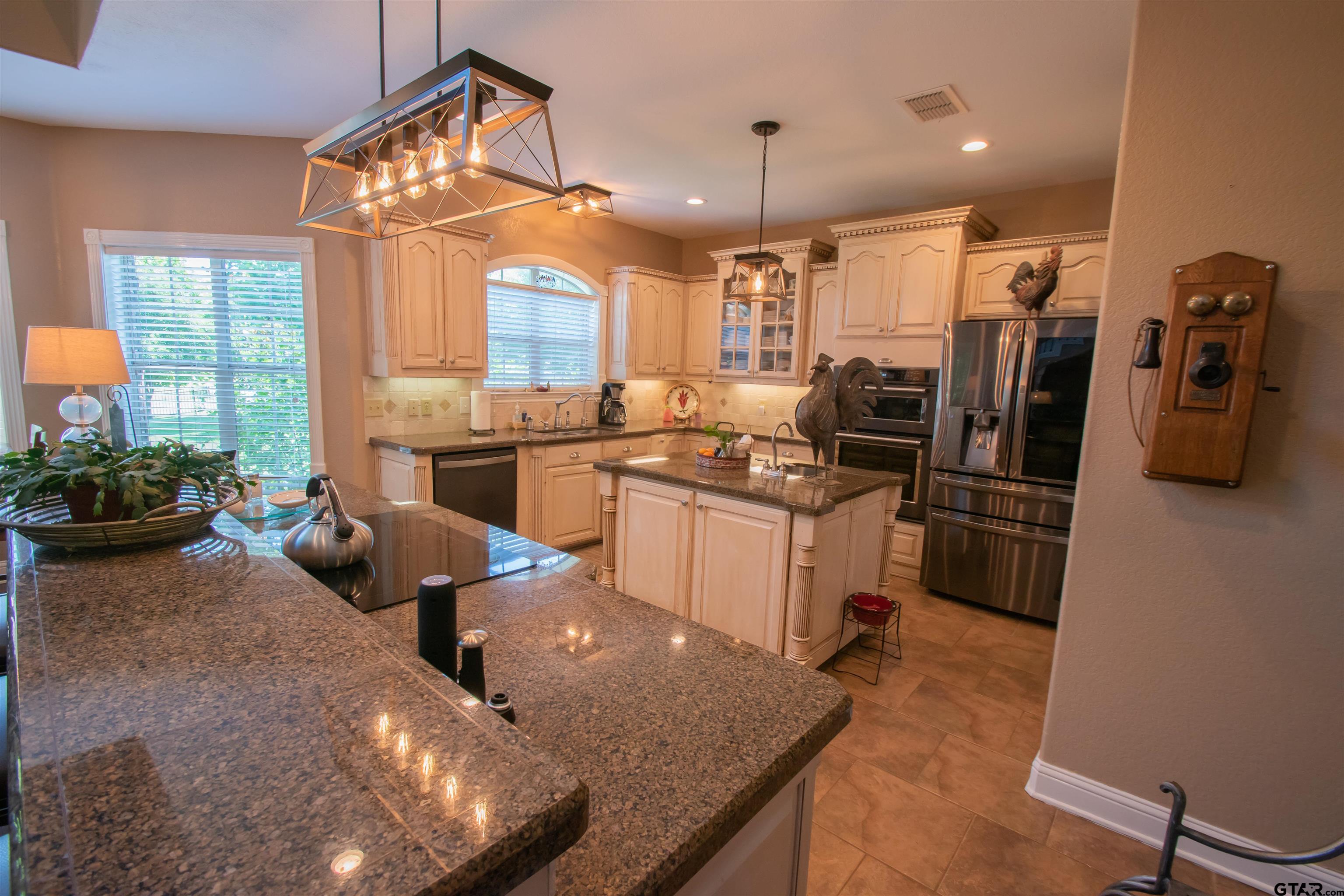 23120 Saddle Ridge Court Lindale, TX 75771 - Photo 6 of 37 a kitchen with refrigerator and chairs