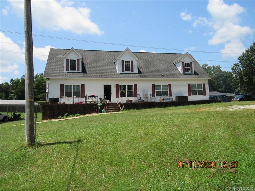 a view of a house with a backyard porch and sitting area
