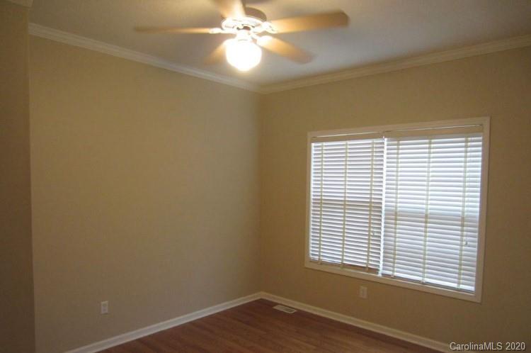 6716 Love Point Road Denver, NC 28037 - Photo 16 of 19 a view of an empty room with wooden floor and a window