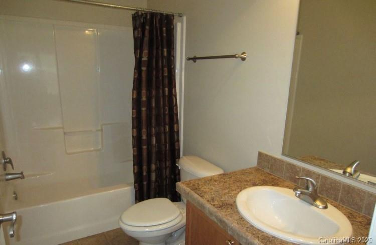 6716 Love Point Road Denver, NC 28037 - Photo 18 of 19 a bathroom with a granite countertop sink toilet and shower