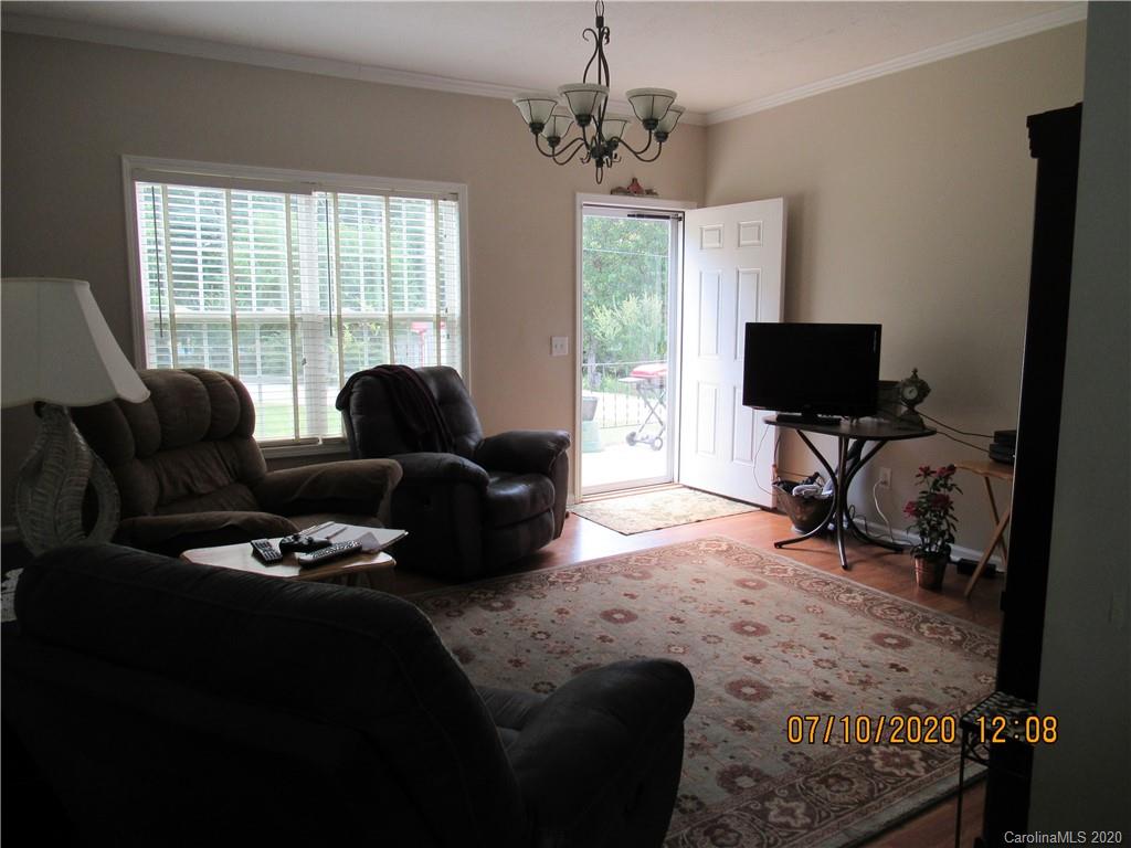 6716 Love Point Road Denver, NC 28037 - Photo 6 of 19 a living room with furniture and a flat screen tv