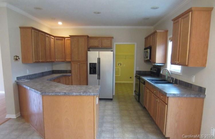 6716 Love Point Road Denver, NC 28037 - Photo 7 of 19 a kitchen with stainless steel appliances granite countertop a refrigerator a sink and a stove