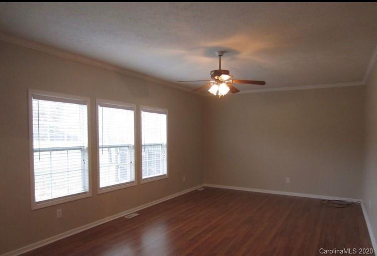 6716 Love Point Road Denver, NC 28037 - Photo 10 of 19 an empty room with wooden floor and windows