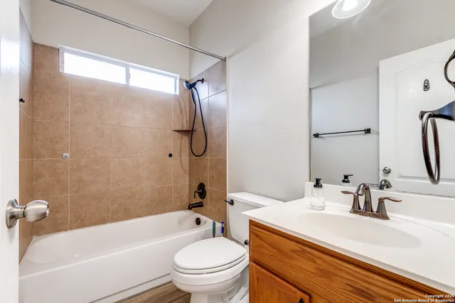 an empty room with windows and ceiling fan