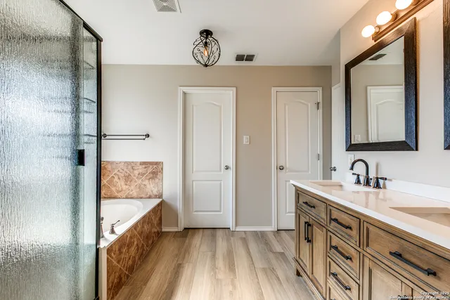 a bathroom with a tub and shower