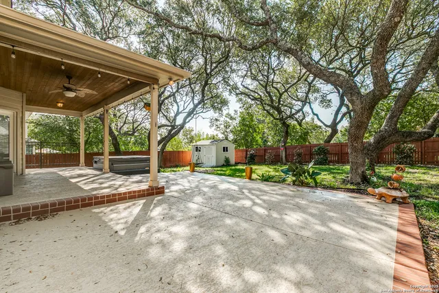 a view of an house with backyard space and balcony