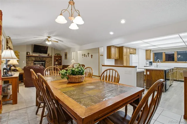 a dining room with furniture a chandelier and window