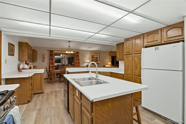 a kitchen with a sink a counter top space stainless steel appliances and cabinets