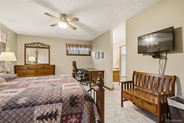 a bedroom with furniture and a flat screen tv