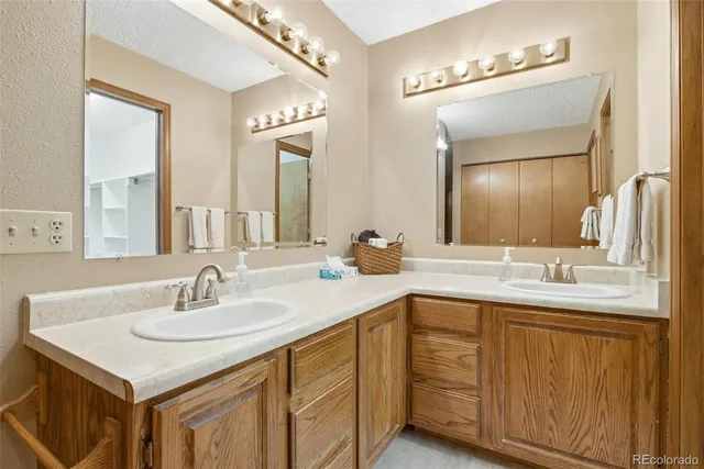 a bathroom with 2 sink and a mirror