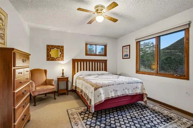 a bedroom with a bed dresser and a window