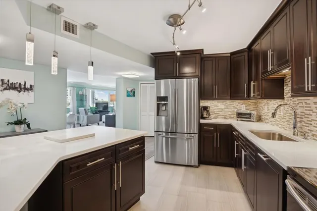 a kitchen with refrigerator cabinets and furniture