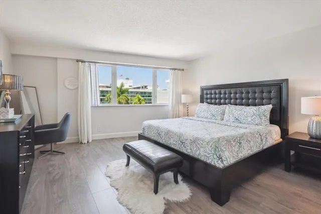 a bedroom with a bed a table and a chair