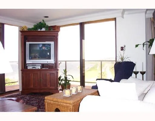 a living room with furniture a window and a flat screen tv