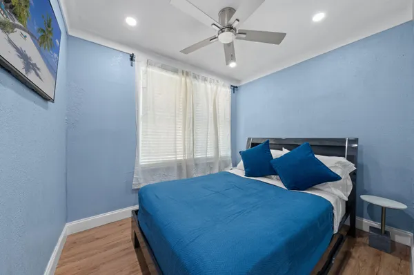 a bed room with a bed and a chair