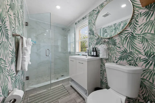 a bathroom with a sink a toilet and a mirror